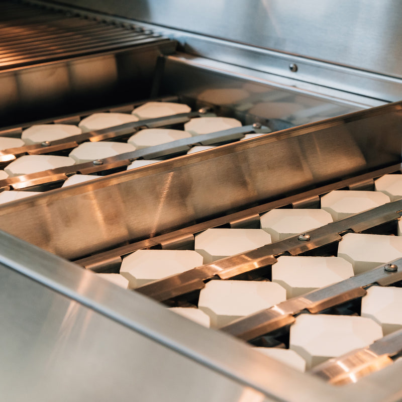 Ceramic briquettes spread heat evenly across the grates, reducing hot spots for more consistent results.