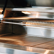 The spacious warming rack above the cooking grates equips you to serve your meals with consistent heat.