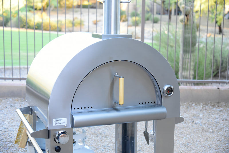 Close-up front view (door closed) of the KoKoMo Dual-Fuel Pizza Oven on stainless steel cart