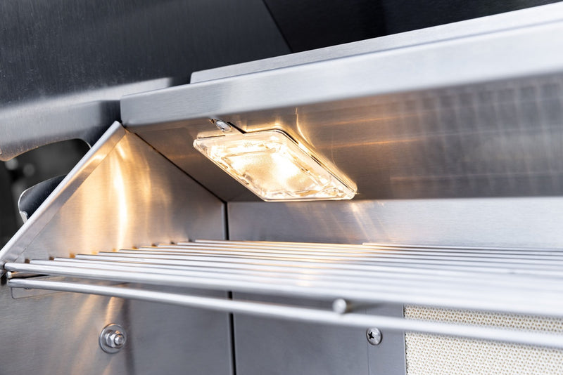 Interior halogen lights and full-width warming rack keep food visible and ready to serve, even during late-night cooks.