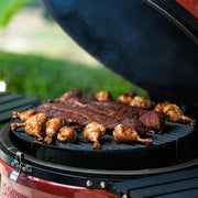 Kamado Joe Big Joe II 24-inch ceramic grill loaded with ribs and chicken drumsticks shows how the large cooking surface handles full family barbecue meals in one cook