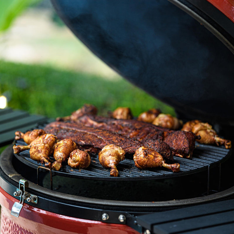 Kamado Joe Big Joe II 24-inch ceramic grill loaded with ribs and chicken drumsticks shows how the large cooking surface handles full family barbecue meals in one cook