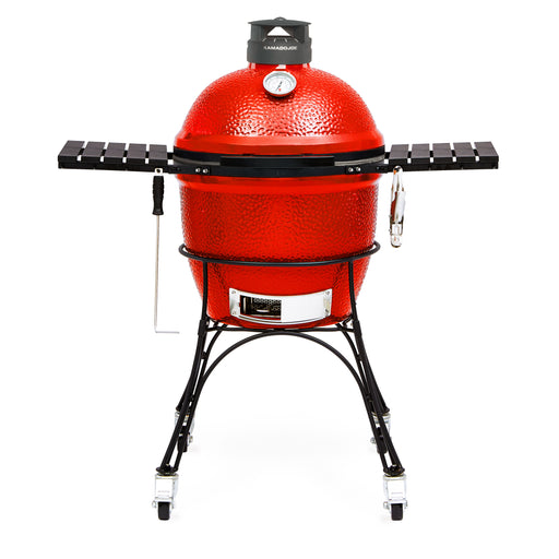 Kamado Joe Classic Joe II 18-inch charcoal grill on cart with side shelves extended, giving backyard cooks extra prep space around the cooker